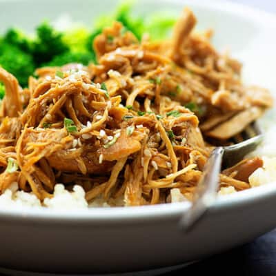 A white bowl of shredded chicken.