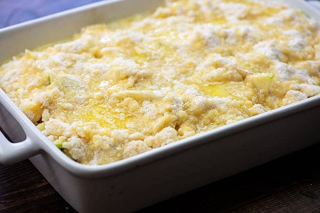 apple cobbler ready for the oven in white baking dish
