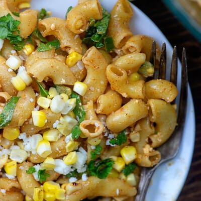 A plate of macaroni noodles and corn.