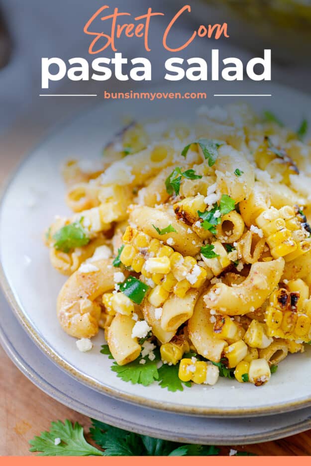 Pasta salad with corn and cilantro on white plate with text for PItnerest.