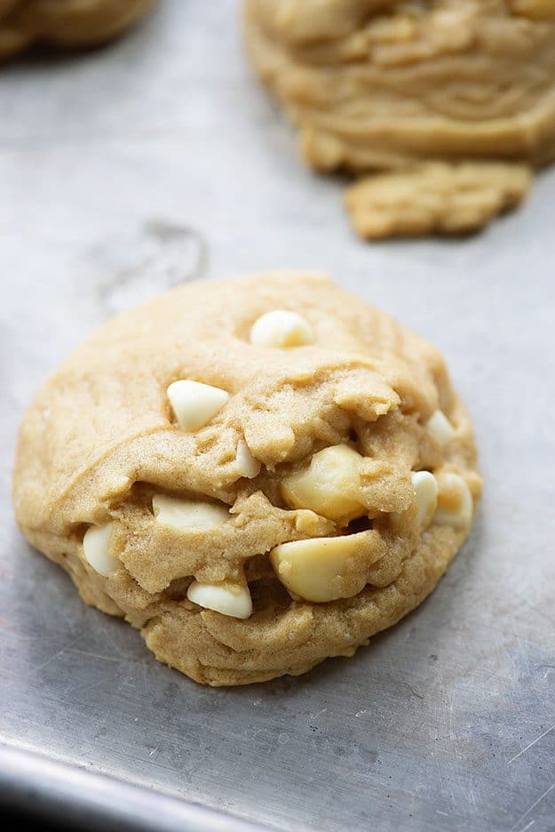 white chocolate macadamia nut cookie on a baking sheet.