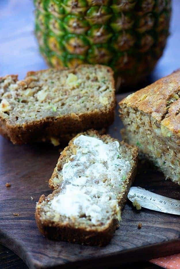 Several pieces of bread on a cutting board.