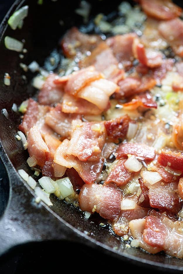 fried bacon and onions in skillet