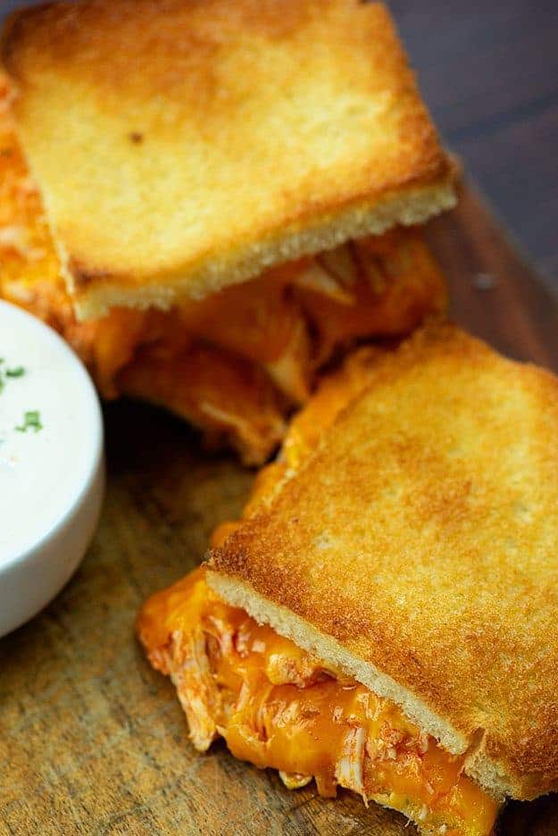 A grilled cheese sandwich on a cutting board.