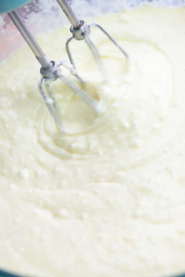 cheesecake batter being mixed in bowl
