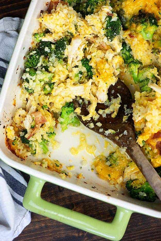 Wooden spoon in a pan of chicken casserole.