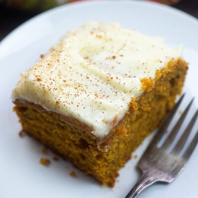 A piece of carrot cake with cream cheese frosting.