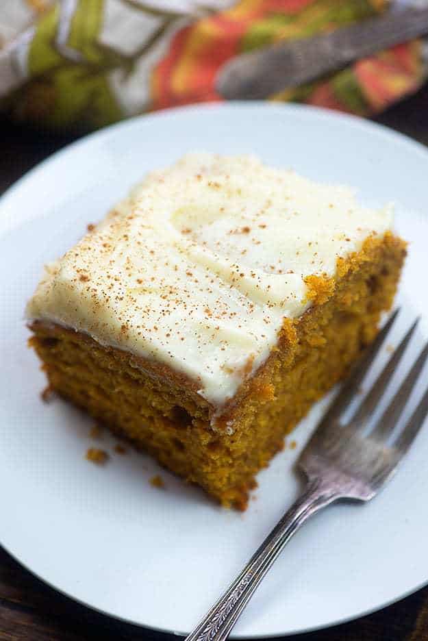 A piece of carrot cake with cream cheese frosting.