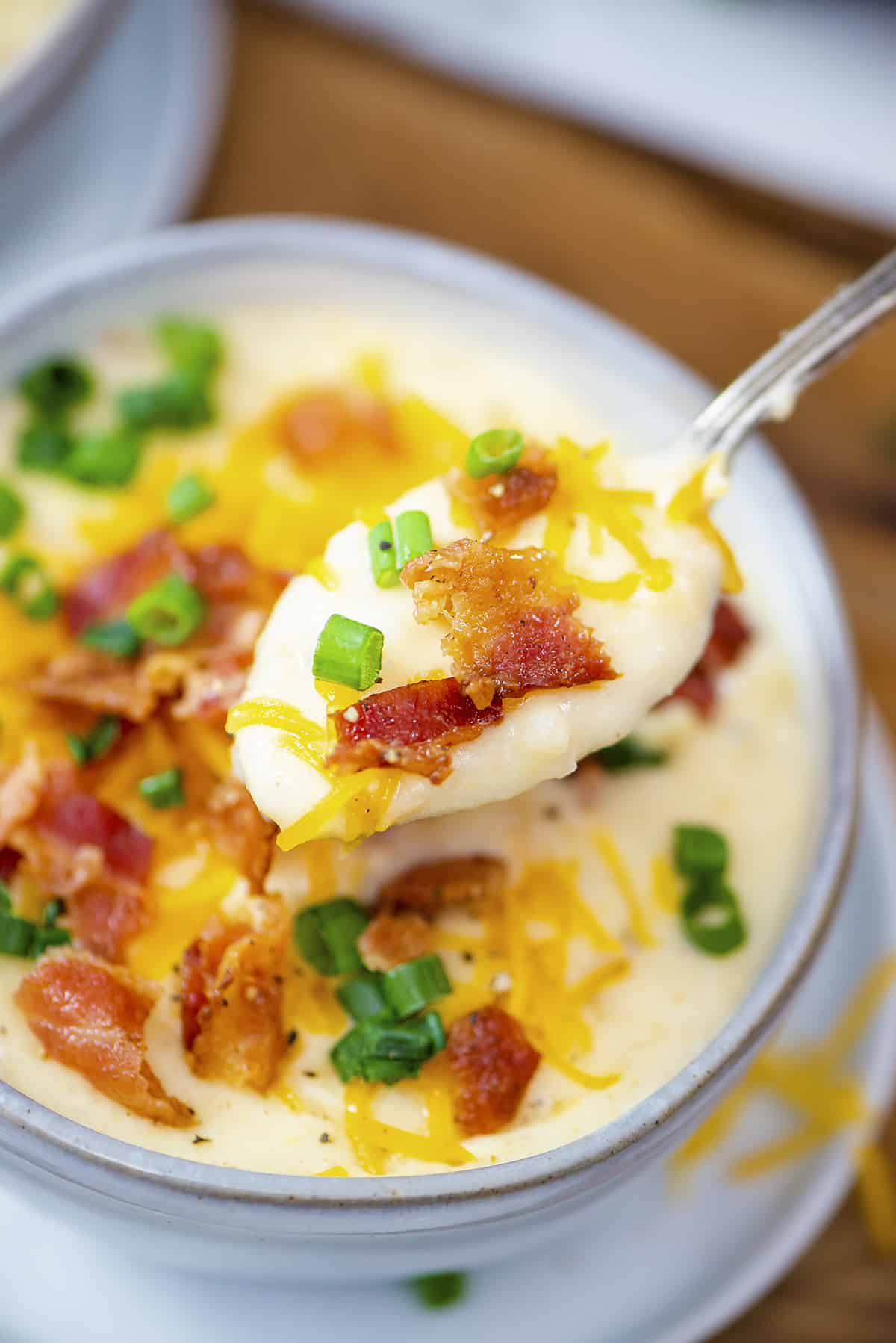 Potato soup on spoon.