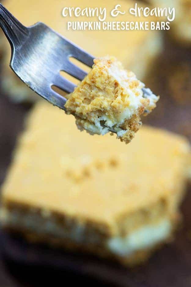 Pumpkin cheesecake on a fork above a square of cheesecake.