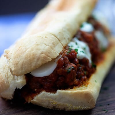 Meatball sandwich on a cutting board.