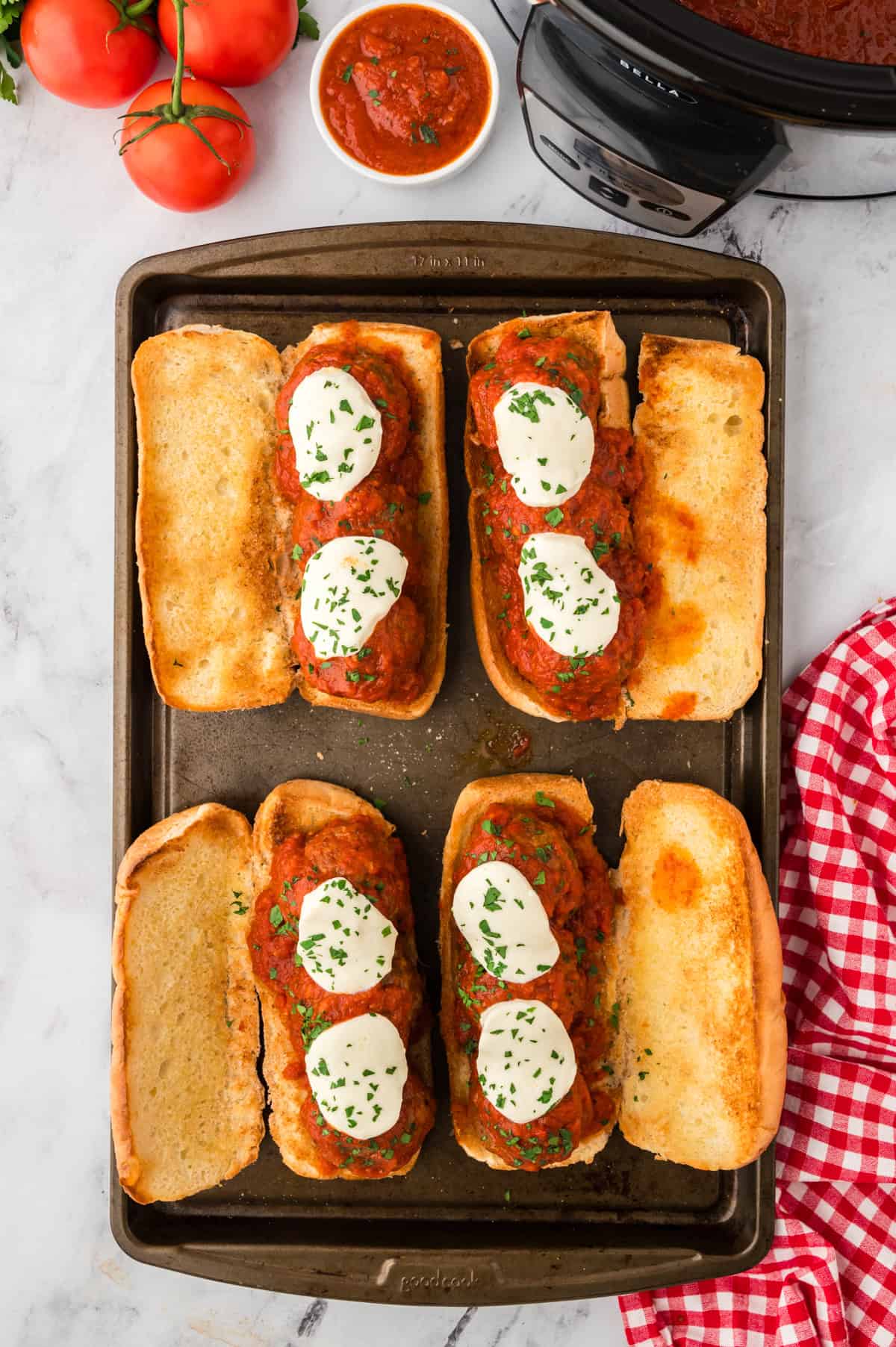 Meatballs, sauce, and mozzarella on hoagie roll.