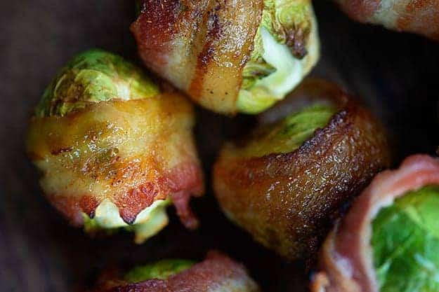 A close up of brussel sprouts wrapped in bacon.