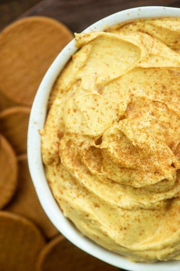 Top-down view of pumpkin pie dip in a white bowl.