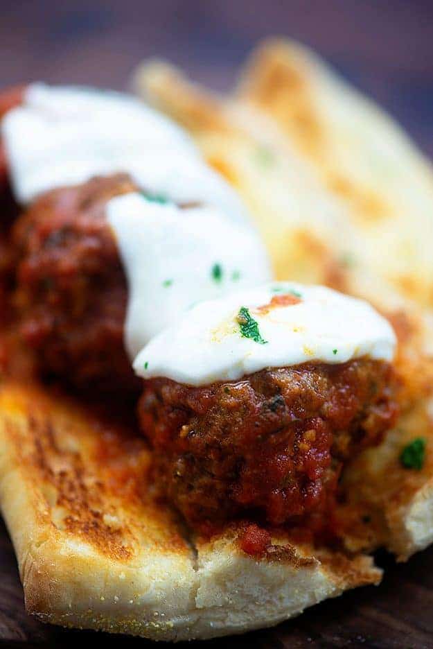 Meatballs with melted cheese on top.