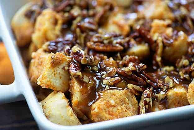 praline topping on french toast casserole in white baking dish