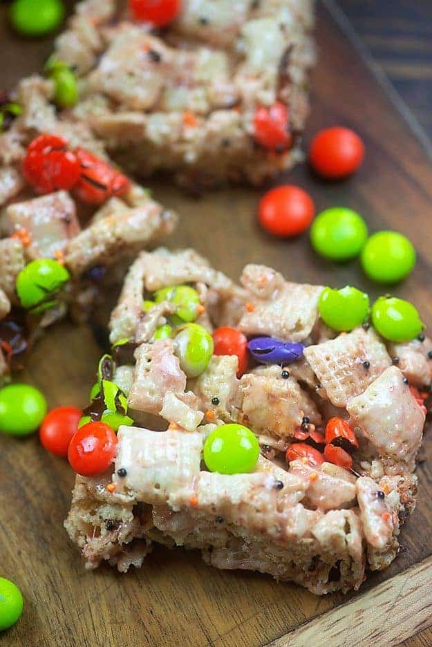 Cereal bars and m&m\'s on a cutting board.