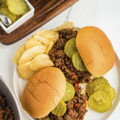 Overhead view of sloppy joes on white plate.