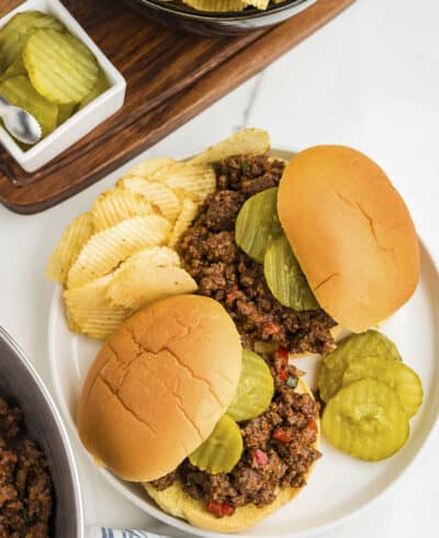 Overhead view of sloppy joes on white plate.