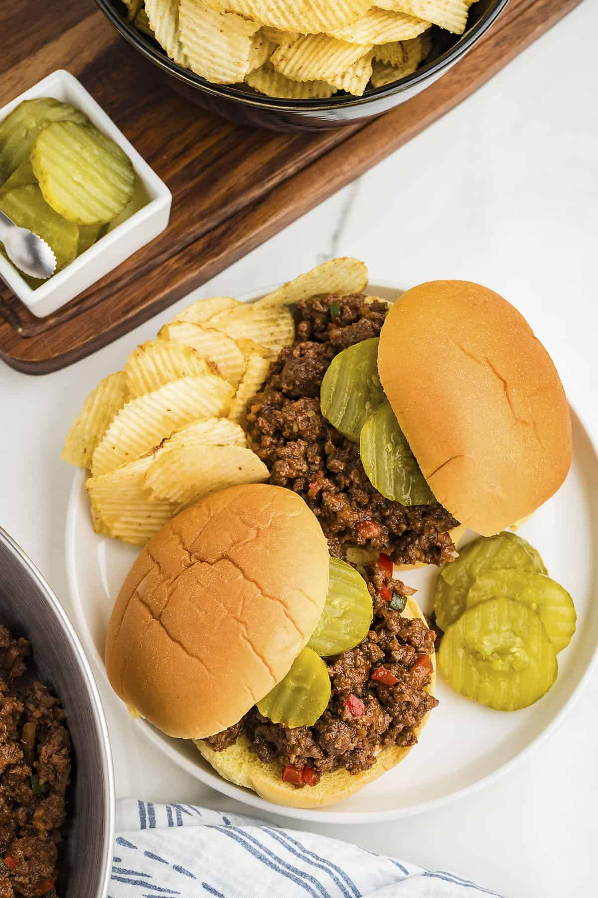 Overhead view of sloppy joes on white plate.