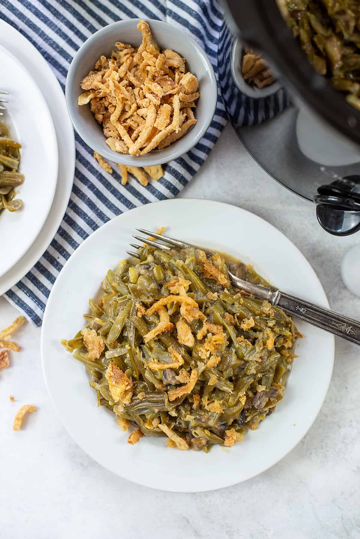 crockpot green bean casserole on white plate.