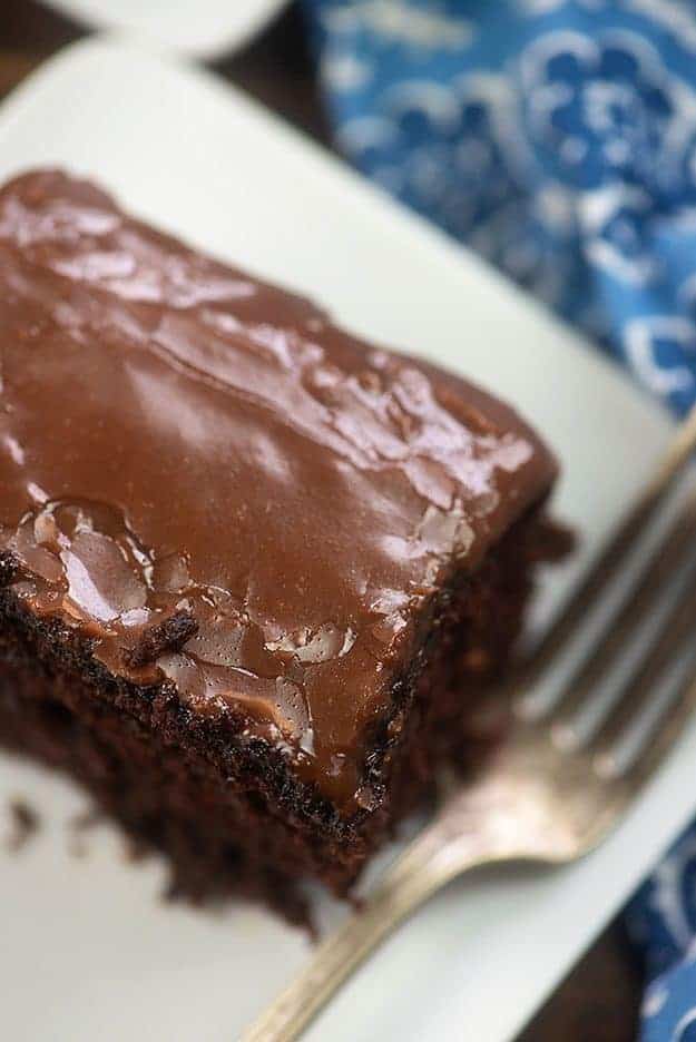 A close up of chocolate cake topped with chocolate frosting.