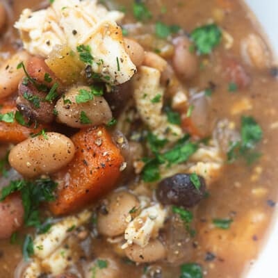 close up of turkey soup in a white bowl.