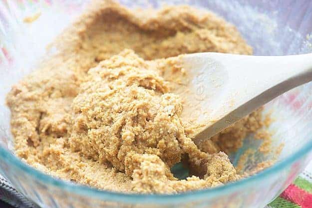 A clear glass bowl of peanut butter filling.