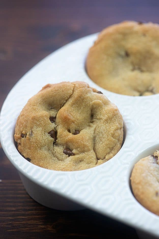 Chocolate chip cookies in a muffin pan.