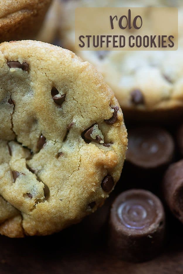 A stuffed chocolate chip cookie on top of some Rolos.