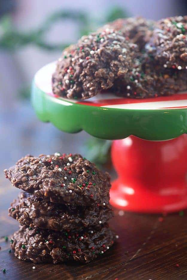 Chocolate cookies with sprinkles on a cake stand.