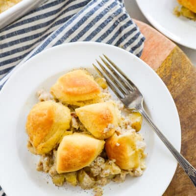 Biscuits and gravy casserole on white plate.