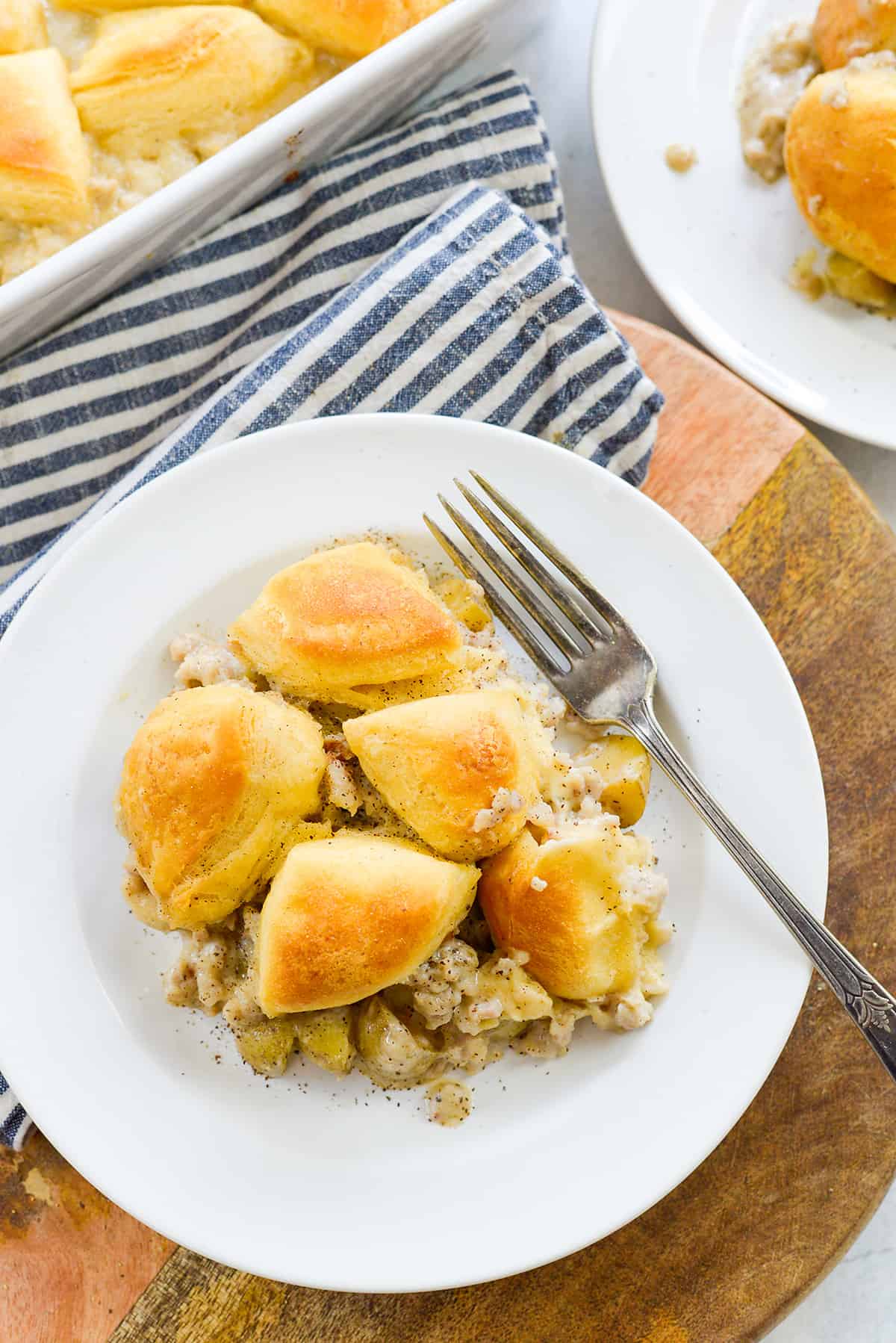 Biscuits and gravy casserole on white plate.