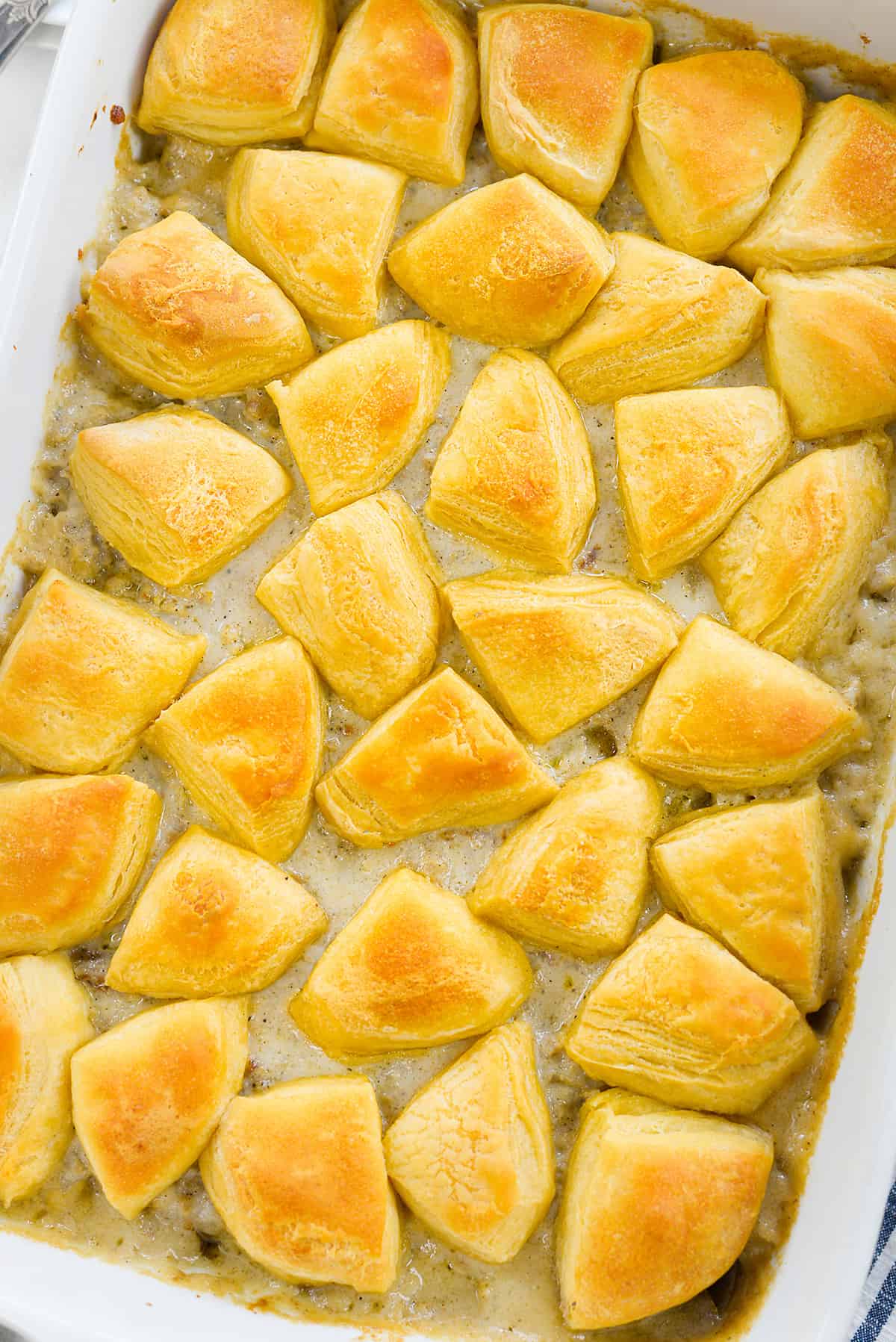 Biscuits and gravy casserole in white baking dish.