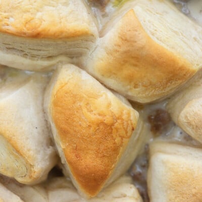 Close up of biscuits on top of a casserole.