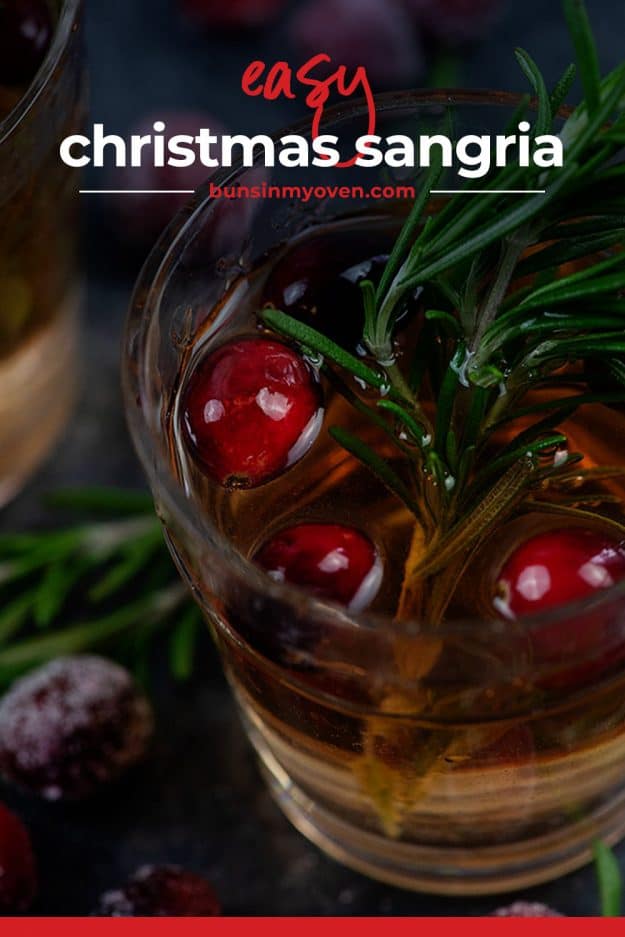 cranberry sangria in glass with rosemary.