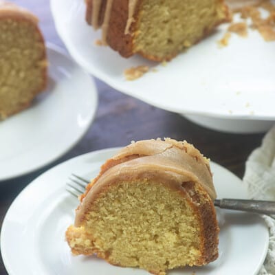 A slice of pound cake on a small white plate.