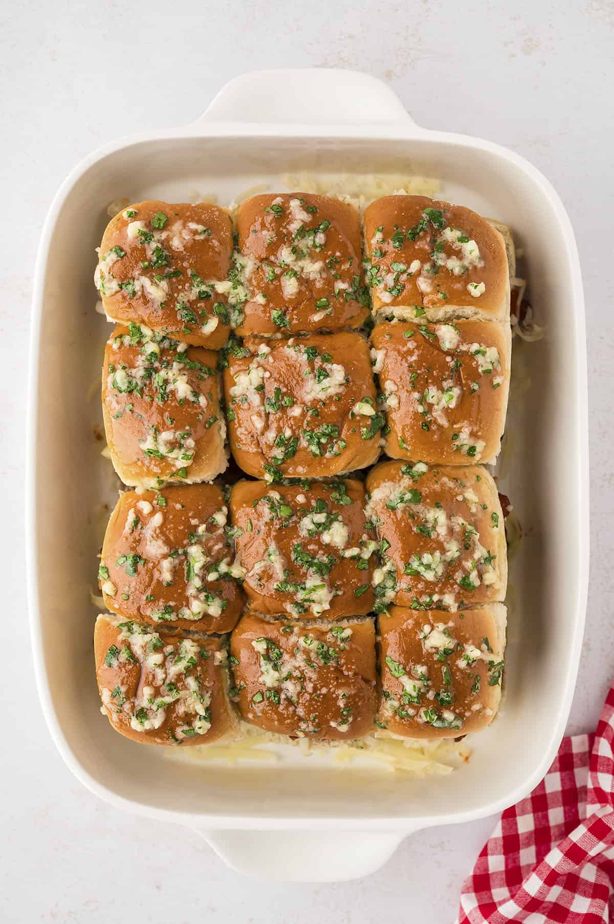 Sliders topped with garlic butter.