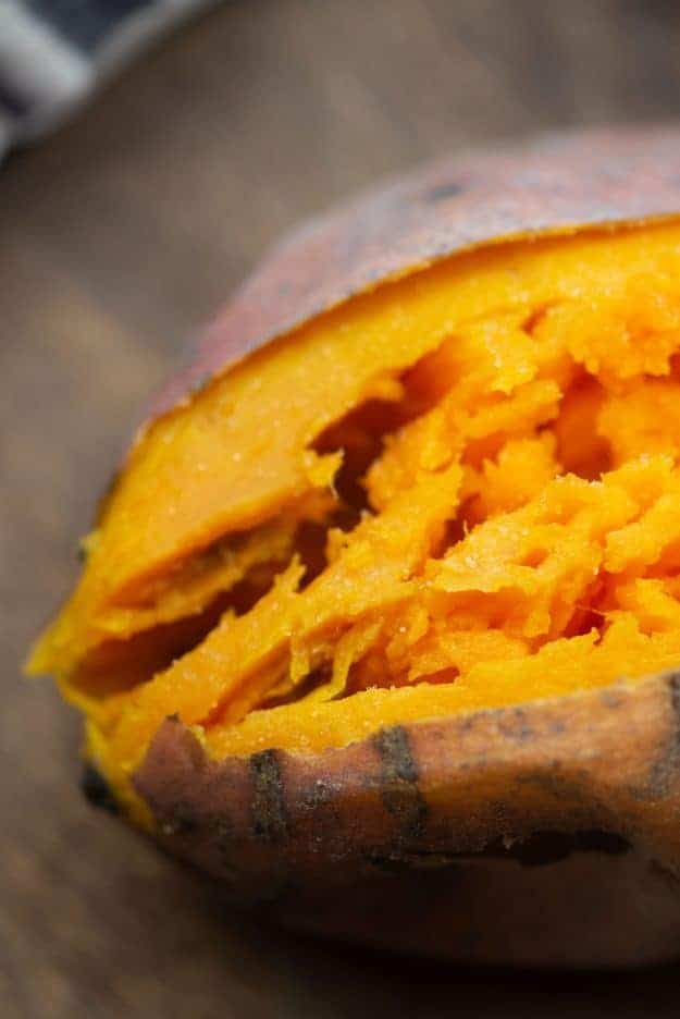 A close up of a cooked and split sweet potato.