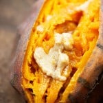A close up of a sweet potato with melted butter in the middle.