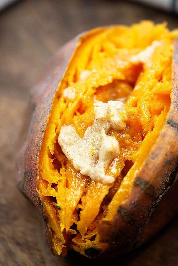 A close up of a sweet potato with melted butter in the middle.