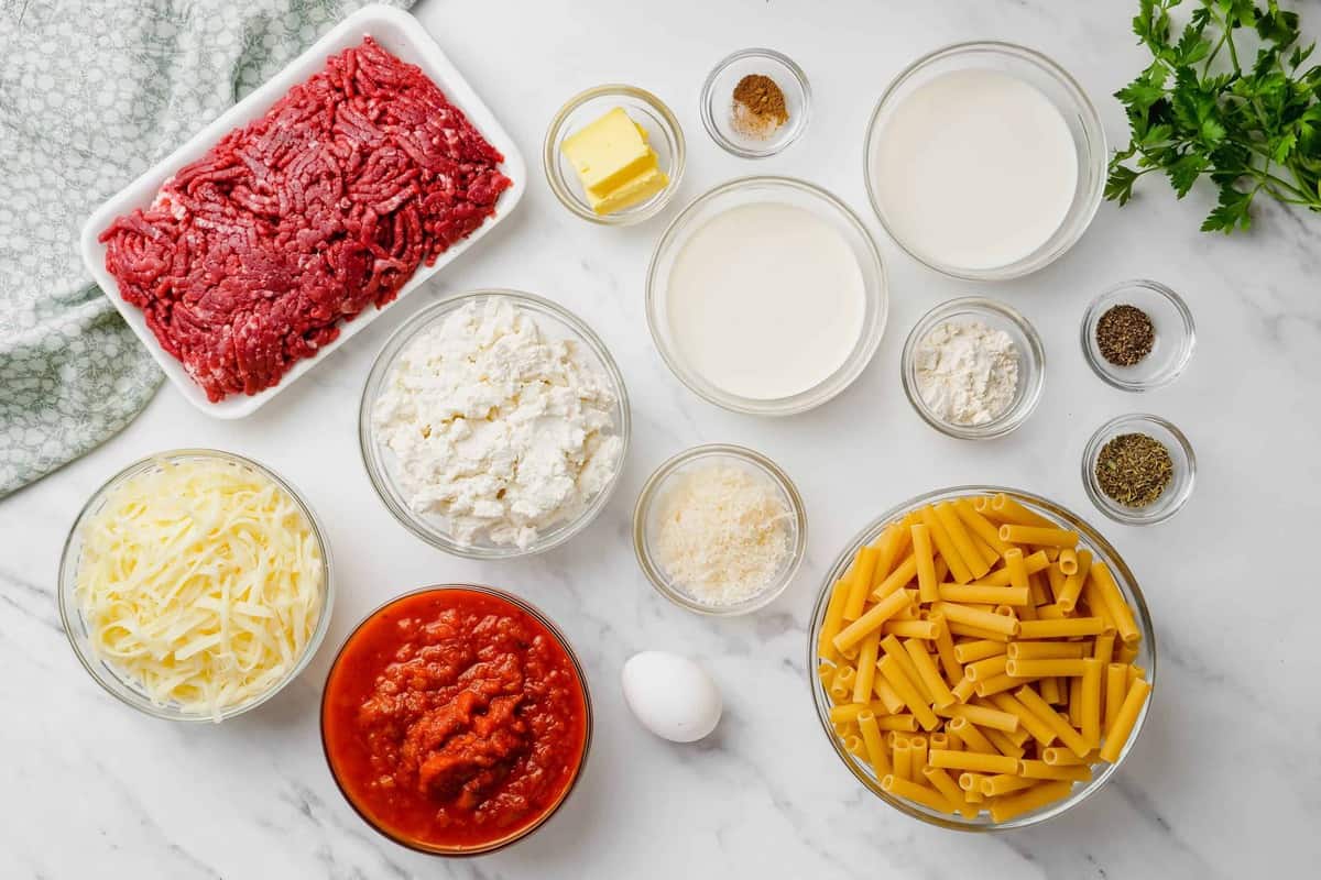 ingredients for baked ziti on white counter.