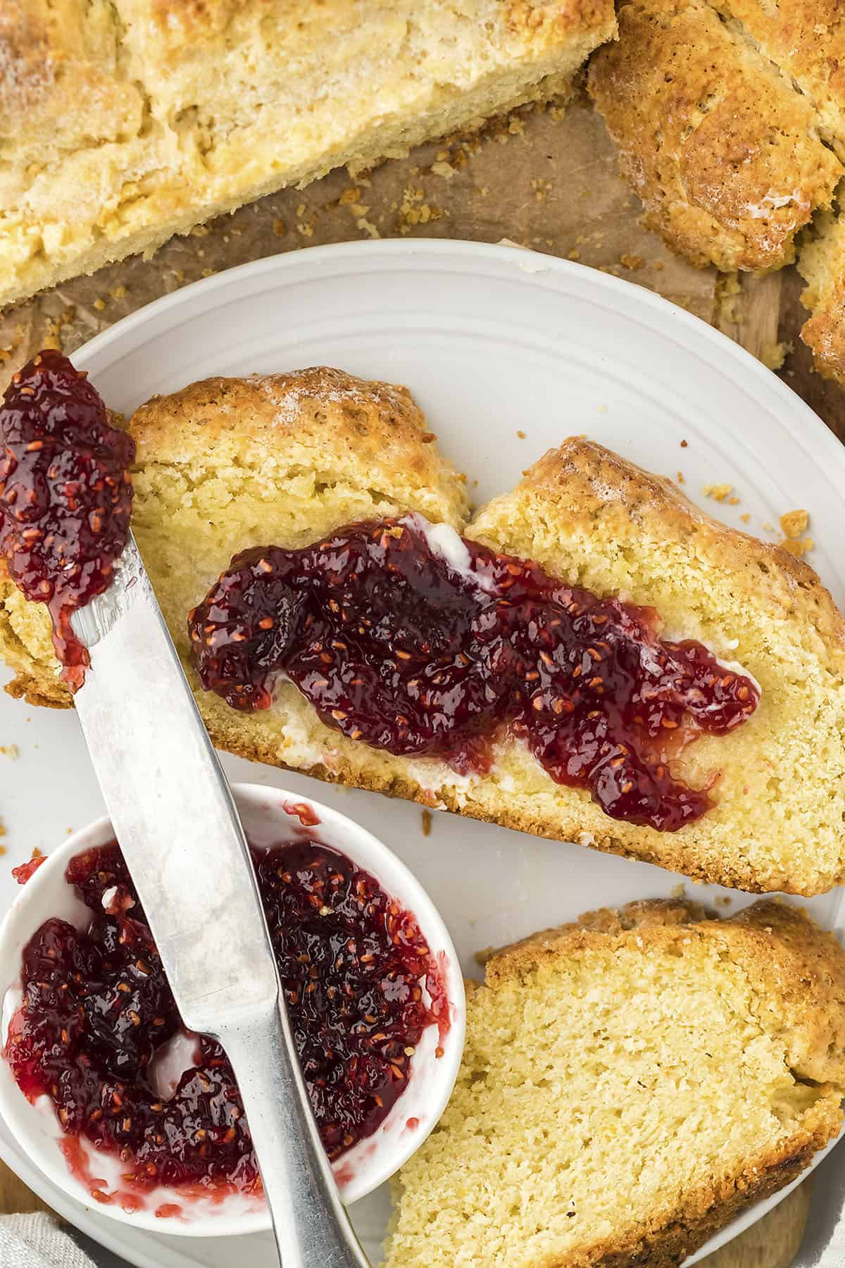 Slice of Irish soda bread with jam spread on top.