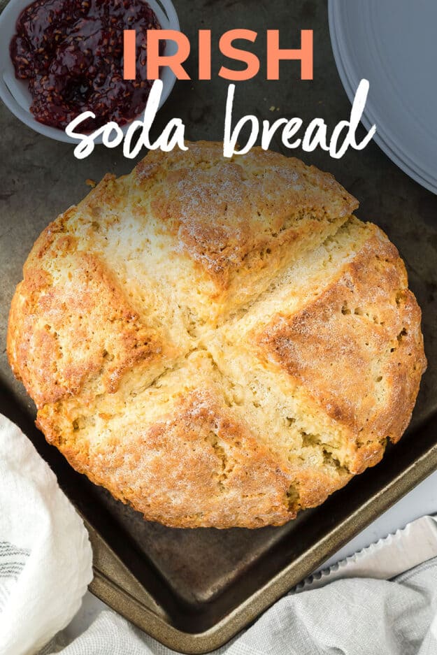 Loaf of Irish soda bread on sheet pan.