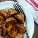 Ranch potatoes on a white plate with the fork