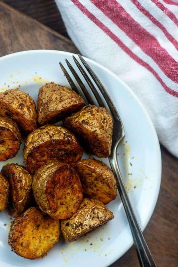 Ranch potatoes on a white plate with the fork 