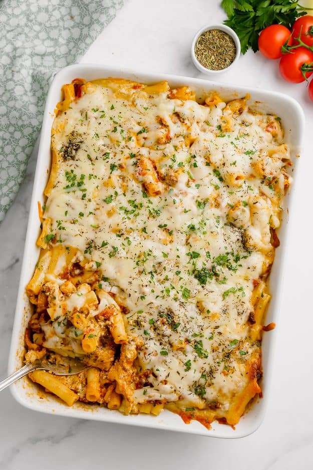 overhead view of baked ziti with meat sauce in white dish.