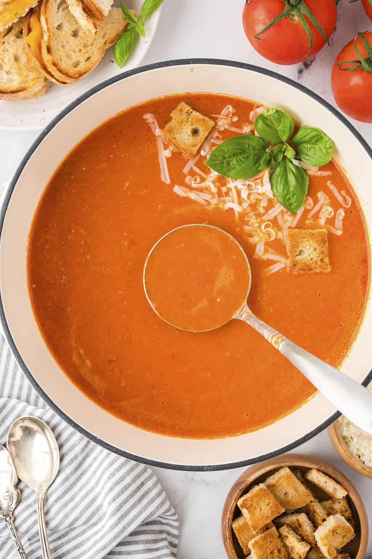 Pot of tomato soup with ladle.