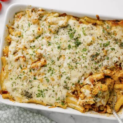Baked ziti with meat in white bakin dish.