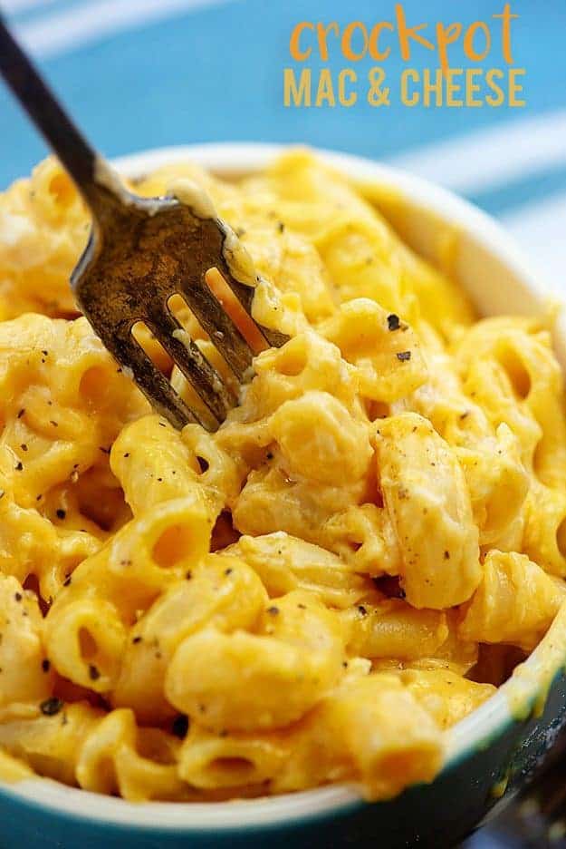 Fork stabbing into a bowl of macaroni and cheese.